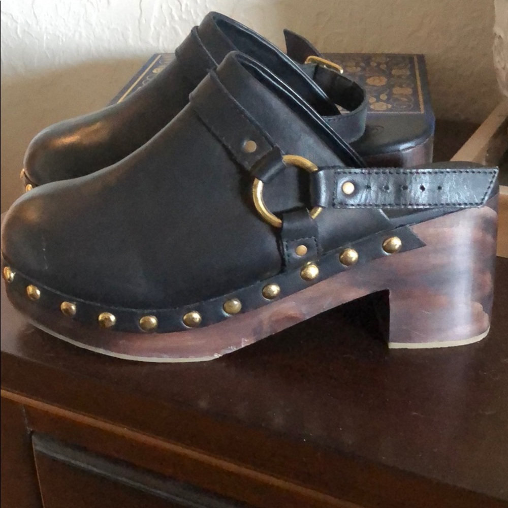 Urban Outfitters black wooden clogs with strap.